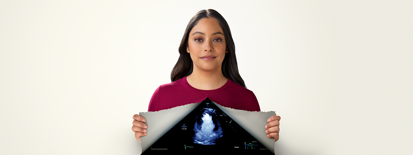 Image of Penny, a young woman and DEFINITY® ambassador, revealing quality medical imaging behind a tear-away concept on her chest