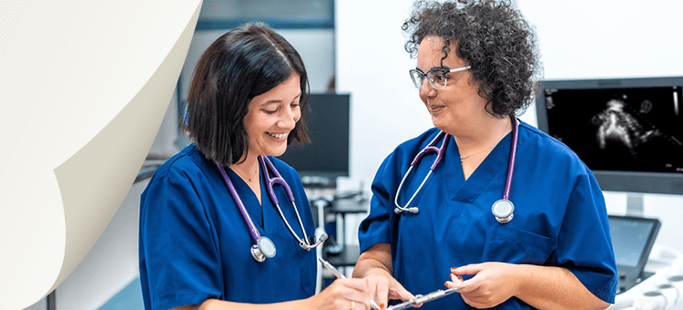 Two healthcare professionals reviewing information on a tablet, discussing the latest updates on DEFINITY®