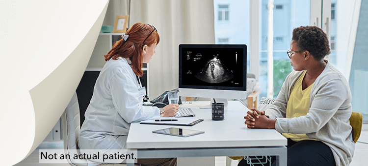 A Healthcare professional discussing ultrasound results to a patient, highlighting the efficacy of DEFINITY® in a clinic setting