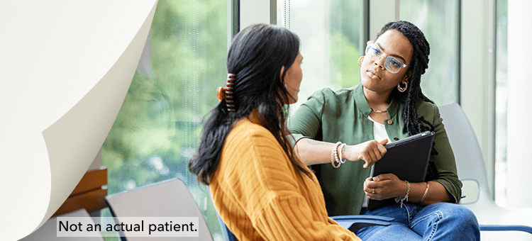 Two adults discussing lab results on a tablet, showcasing lab efficiency with DEFINITY® in a clinical environment