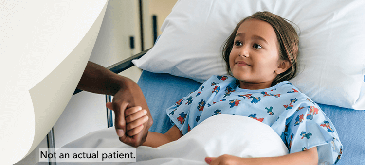 Young patient in a hospital bed under observation, illustrating the safety profile of DEFINITY®