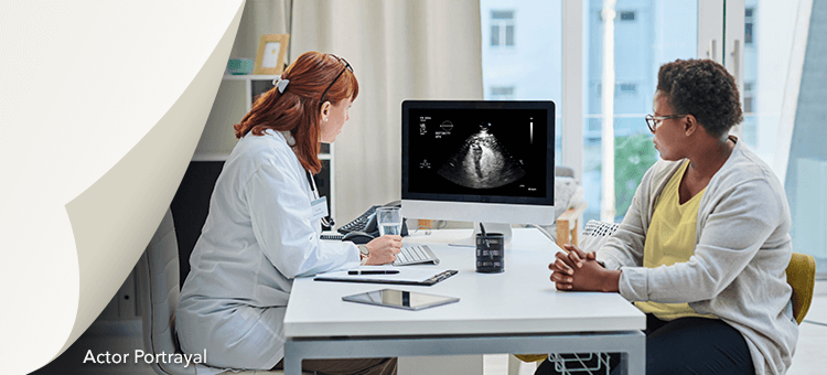 A Healthcare professional discussing ultrasound results to a patient, highlighting the efficacy of DEFINITY® in a clinic setting