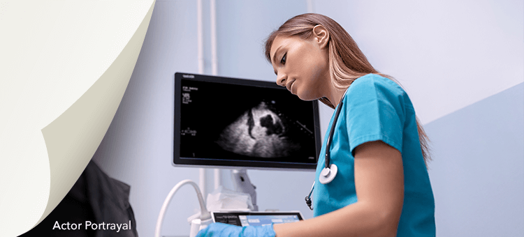 Healthcare professional analyzing an ultrasound image on a monitor, demonstrating Definity's role in image optimization